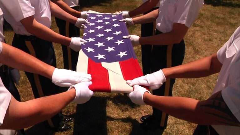 close shot of American flag in hands, they are folding the flag.