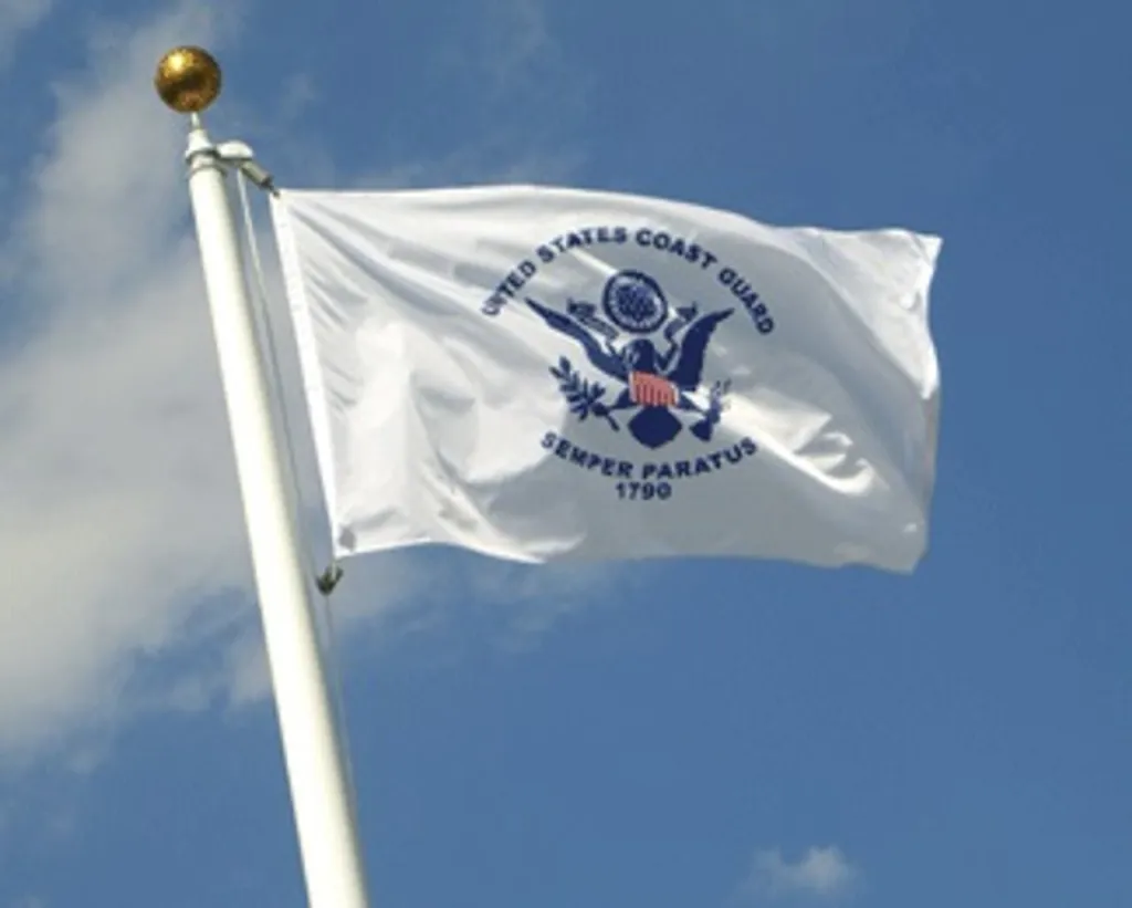 US coast guard flag flying on the poll.