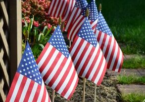 Stick Flags on display along a garden path
