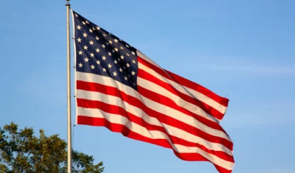 american flag flying on a pole.