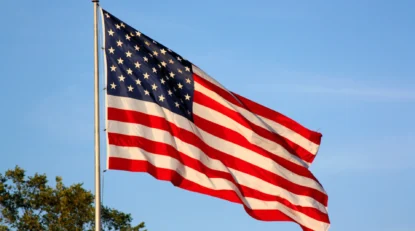 american flag flying on a pole.